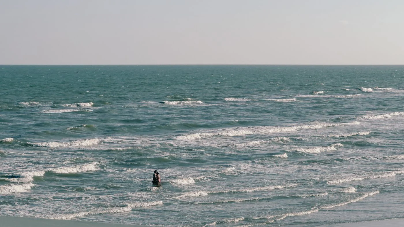 Visitors on Galveston's sandy shore