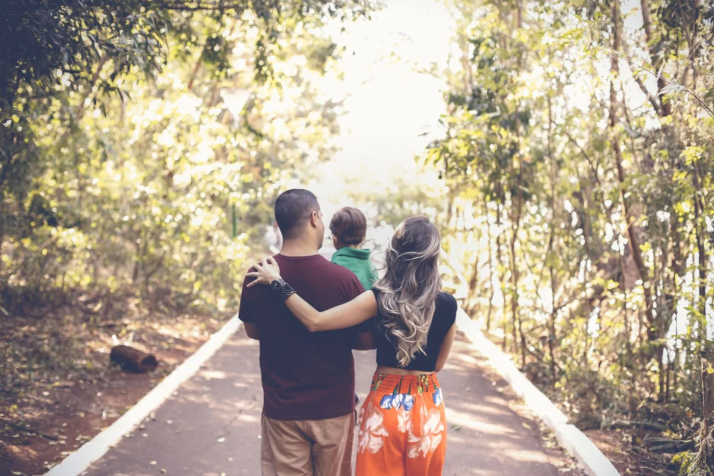 Adults and children walking together along a park path